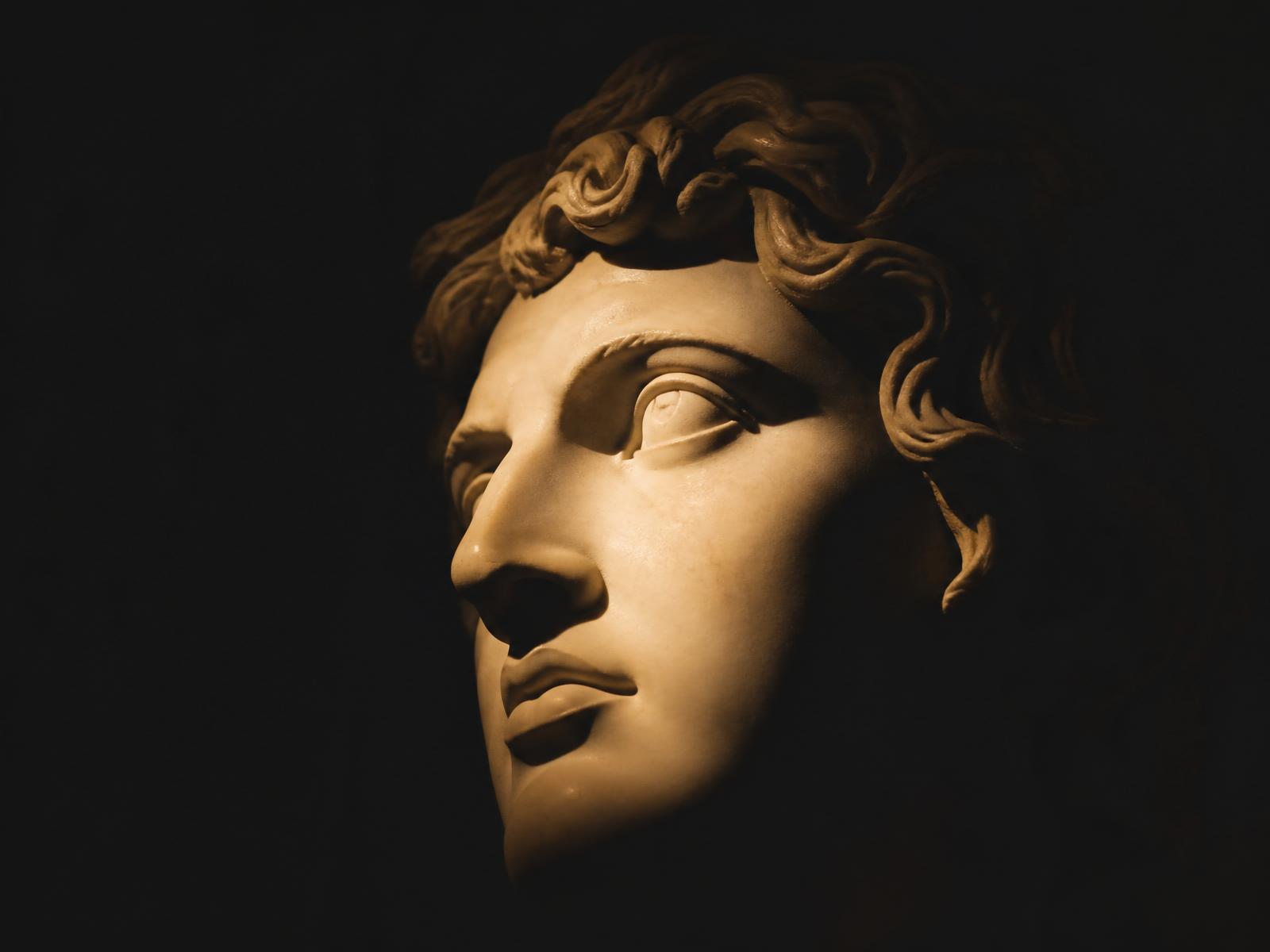 Marble bust emerging from shadow into light